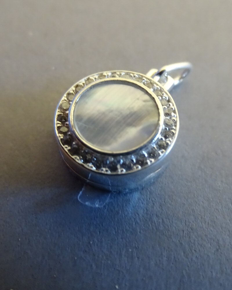 SMALL ROUND SILVER LOCKET WITH M.O.P